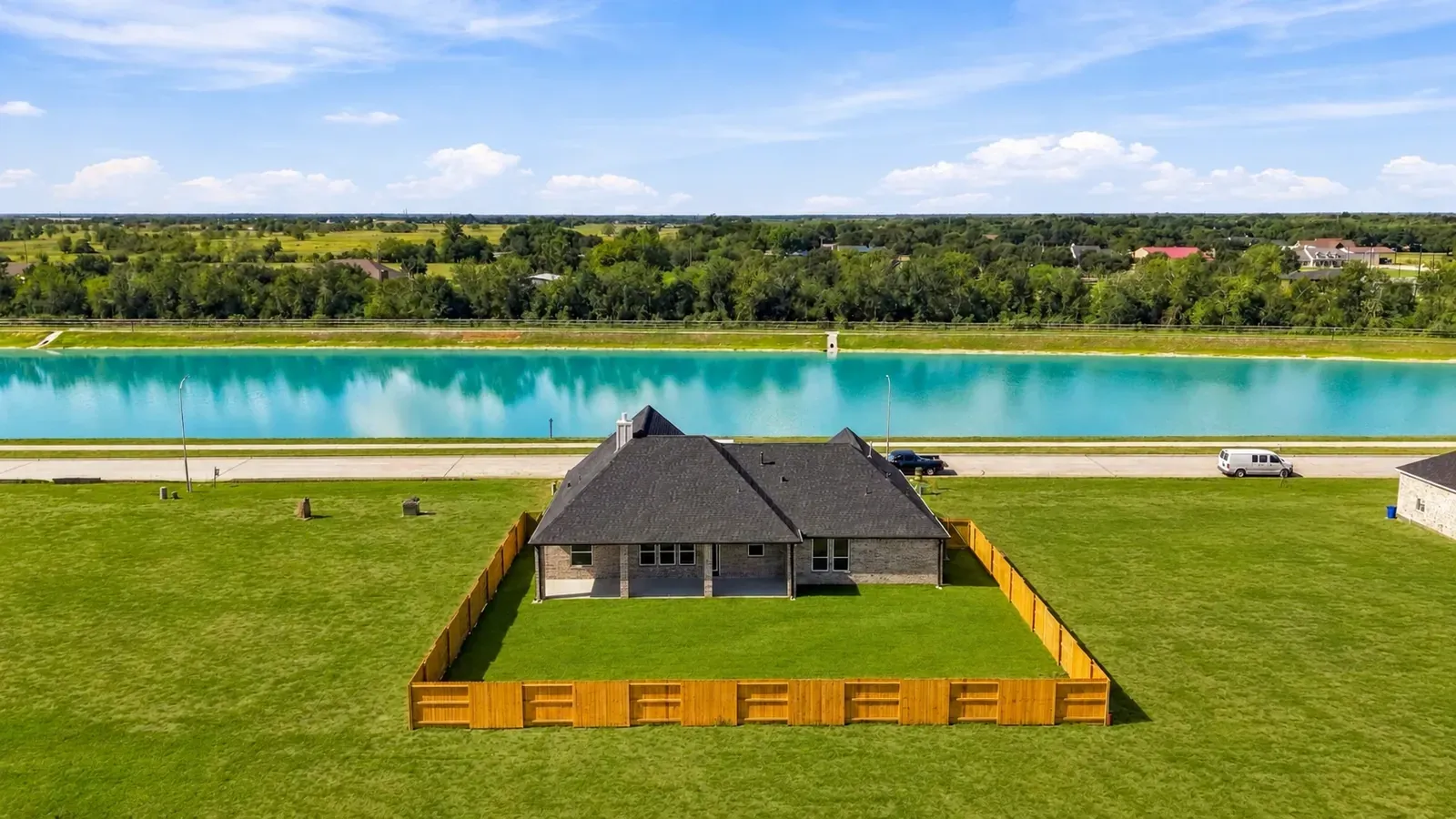 Aerial view of the fenced backyard and the lake